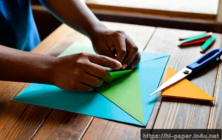 Home 17 종이공예 작품 만들기 과정 - Photorealistic overhead view of a pair of adult hands carefully folding colorful paper into a detail...
